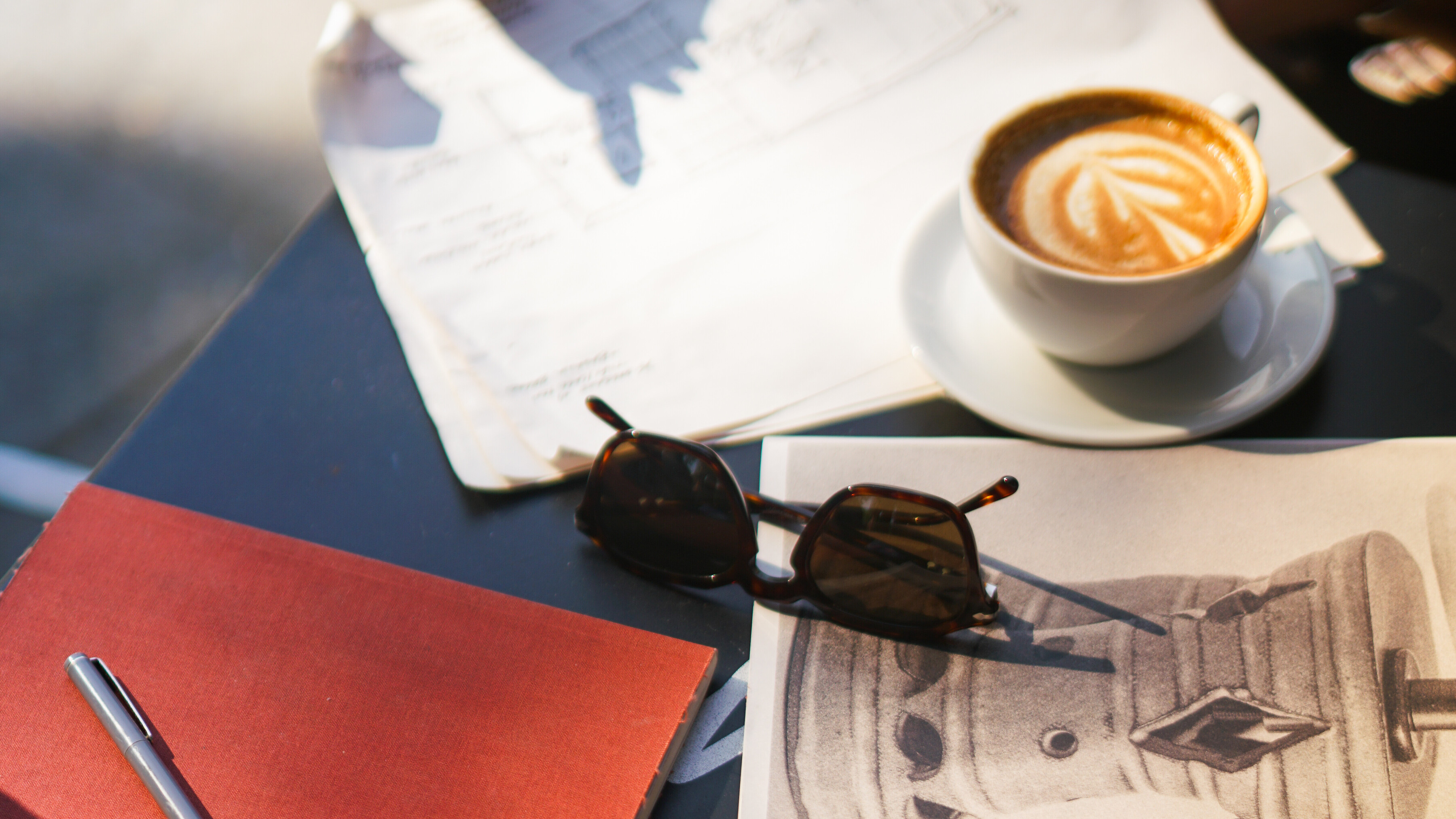 Interiors Team Working at Cafe Kitsune In West Village with Red Notebook